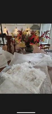 a pile of white feathers on a table with flowers at WS77 B&B Apartment in Leiden