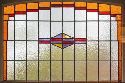 a stained glass window with a cross on it at Cosy Dutch Delight Apartment in Santpoort-Zuid