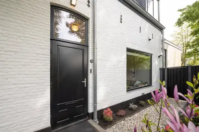 a black door on the side of a building at Cosy Dutch Delight Apartment in Santpoort-Zuid