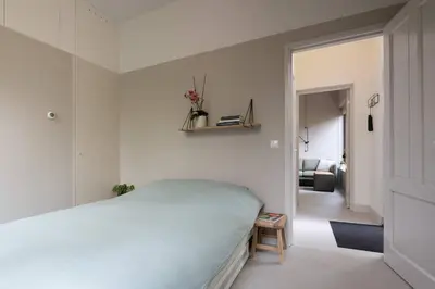 a bedroom with a bed and a living room at Cosy Dutch Delight Apartment in Santpoort-Zuid