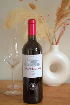 a bottle of red wine sitting next to a glass at Het Wapen van Noordwijkerhout in Noordwijkerhout