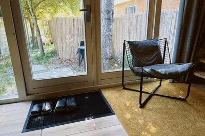 a chair sitting in a room next to a door at A tiny house - Amsterdam region in Lelystad