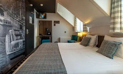 a bedroom with a large bed in a room at Hotel Cornelisz in Amsterdam