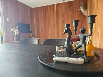 a table with a tray with two figurines on it at Ben's Cabine - De Hollandse Boerderij in Bodegraven