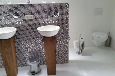 a bathroom with two sinks and a toilet at Riante Boerderij in Het Groene Hart Regio Utrecht in Oudewater