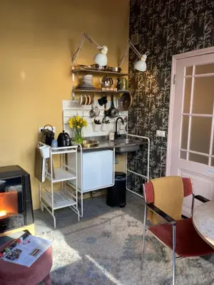 a kitchen with a counter and a table and chairs at Deborah's Hiding Place in Alkmaar