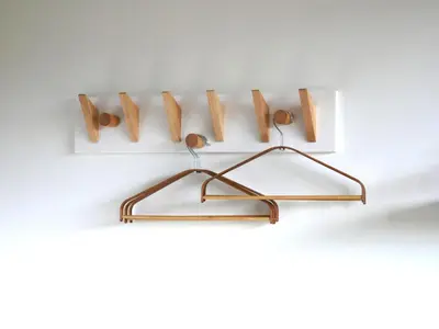a shelf with wooden hooks on a wall at Zandkasteel Zandvoort in Zandvoort