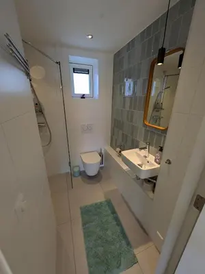 a bathroom with a sink and a toilet and a mirror at Zandkasteel Zandvoort in Zandvoort