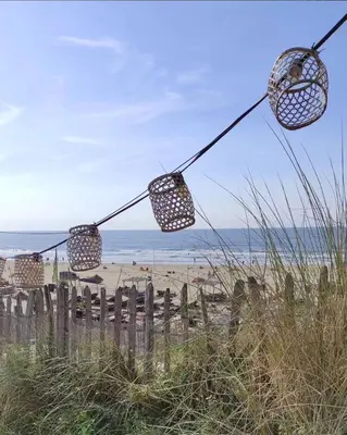 a pair of lights hanging over a beach at Zandkasteel Zandvoort in Zandvoort