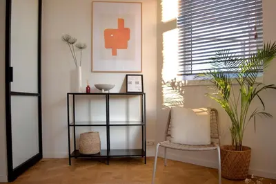 a room with a chair and a shelf and a plant at Luxury room with private bathroom on great location. in Amsterdam