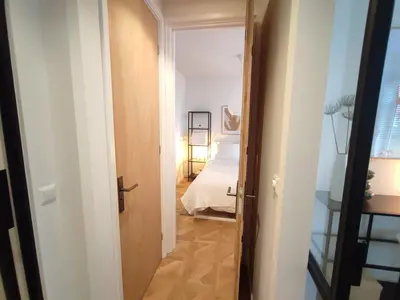 a hallway with a door leading to a bedroom at Luxury room with private bathroom on great location. in Amsterdam