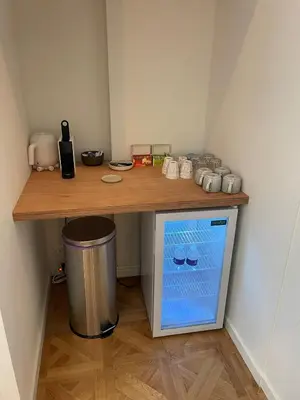 a wooden counter with a trash can under a table at Luxury room with private bathroom on great location. in Amsterdam