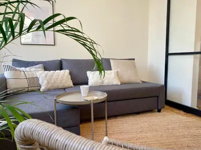 a living room with a blue couch and a table at Luxury room with private bathroom on great location. in Amsterdam