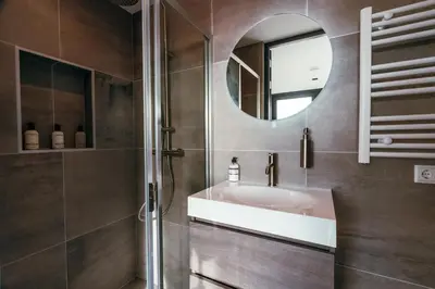 a bathroom with a sink and a mirror at Bos, duin en strand huisje in Noordwijk