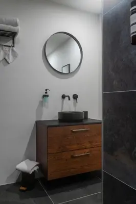 a bathroom with a sink and a mirror on a dresser at B&B Hartenlust kamer de Bedstee in Bodegraven