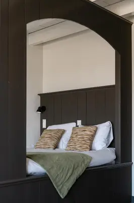 a bed with two pillows on top of it at B&B Hartenlust kamer de Bedstee in Bodegraven