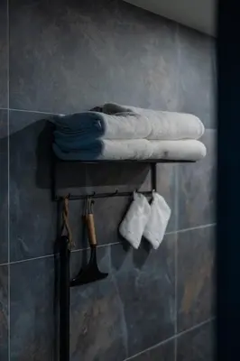 a shelf in a bathroom with towels and socks at B&B Hartenlust kamer de Boomgaard in Bodegraven