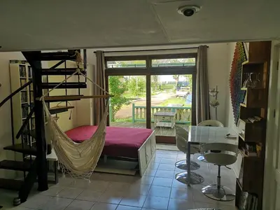 a room with a hammock and a table and a window at Sweet Tiny House in Westbeemster