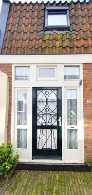 a house with a black and white door at Studio Nieuwland in Alkmaar