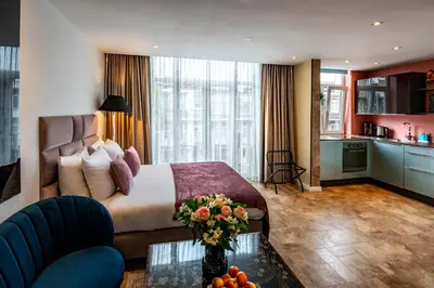 a hotel room with a bed and a kitchen at Jupiter Hotel in Amsterdam