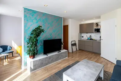 a living room with a flat screen tv at Jupiter Hotel in Amsterdam