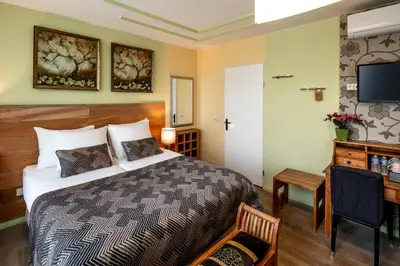 a hotel room with a bed and a television at Jupiter Hotel in Amsterdam