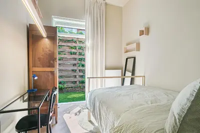a bedroom with a bed and a window at Stylish apartment next to the Amstel River - Unit B in Amsterdam