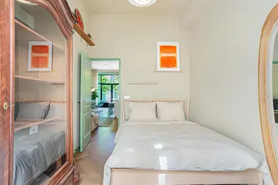 a bedroom with two beds and a mirror at Stylish apartment next to the Amstel River - Unit B in Amsterdam