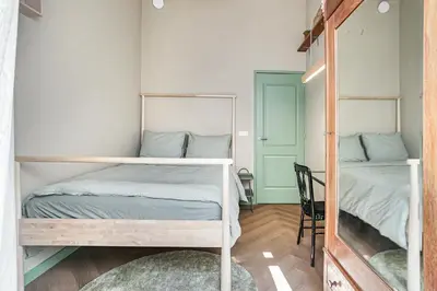 a bedroom with two bunk beds and a chair at Stylish apartment next to the Amstel River - Unit B in Amsterdam