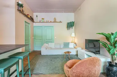 a living room with a couch and a tv at Stylish apartment next to the Amstel River - Unit B in Amsterdam