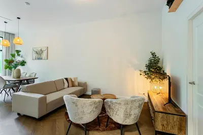 a living room with a couch and a table at Stylish apartment next to the Amstel River - Unit C in Amsterdam