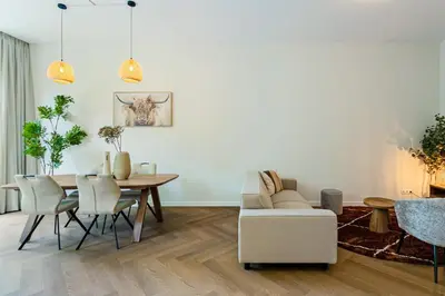 a living room with a table and a couch at Stylish apartment next to the Amstel River - Unit C in Amsterdam