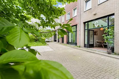 a cobblestone street in front of a building at Stylish apartment next to the Amstel River - Unit C in Amsterdam
