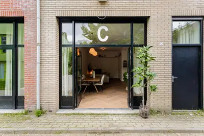an open door of a building with a table inside at Stylish apartment next to the Amstel River - Unit C in Amsterdam