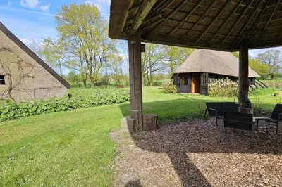 a gazebo with a table and chairs in a yard at Natuurhuisje op Landgoed Groot Diermen in Putten