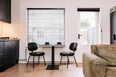 a kitchen with a table and two chairs and a couch at Malu in Zandvoort