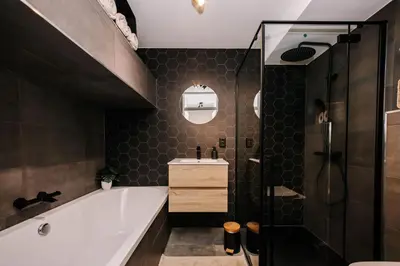 a bathroom with a tub and a shower and a sink at Malu in Zandvoort