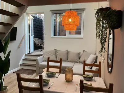 a living room with a couch and a table at Nieuwe vakantie woning nabij het strand - Egmond at the Beach House in Egmond aan Zee