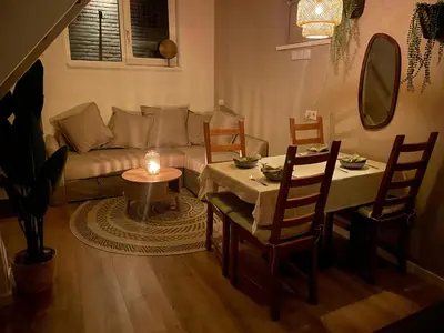 a living room with a couch and a table with a candle at Nieuwe vakantie woning nabij het strand - Egmond at the Beach House in Egmond aan Zee
