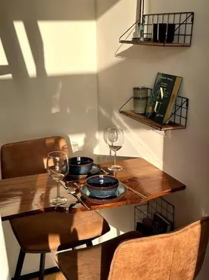 a wooden table with wine glasses on top of it at Tiny house of Picasso in Warmenhuizen