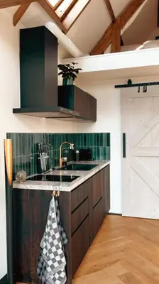 a kitchen with a sink and a counter top at Tiny house of Picasso in Warmenhuizen
