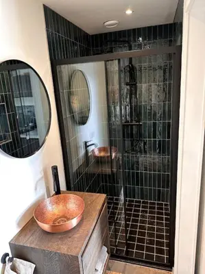 a bathroom with a sink and a shower at Tiny house of Picasso in Warmenhuizen