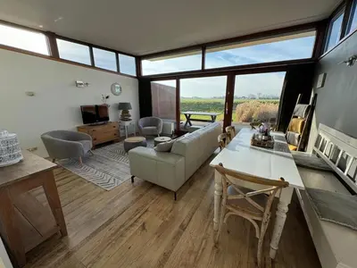 a living room with a couch and a table at Marina VILLA nabij water met prive sauna. in Spakenburg