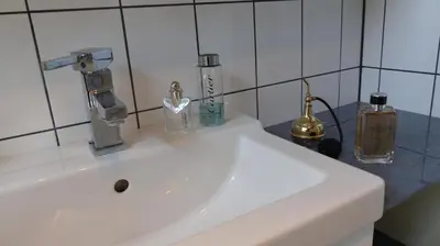 a white sink with two bottles on top of it at Marina VILLA nabij water met prive sauna. in Spakenburg