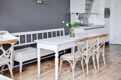 a kitchen with a white table and chairs at Marina VILLA nabij water met prive sauna. in Spakenburg