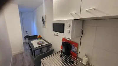 a small room with a tv on a wall at BnB Souterrain in Amsterdam