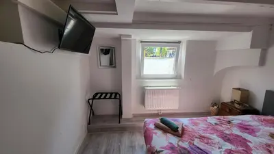 a bedroom with a bed and a television on the wall at BnB Souterrain in Amsterdam