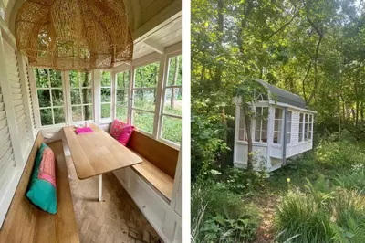 a screened in porch with a table and a gazebo at Magical Woods in Bergen
