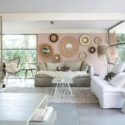 a living room with a white couch and a pink wall at Magical Woods in Bergen