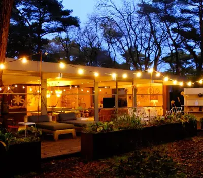 a patio lit up at night with lights at Magical Woods in Bergen